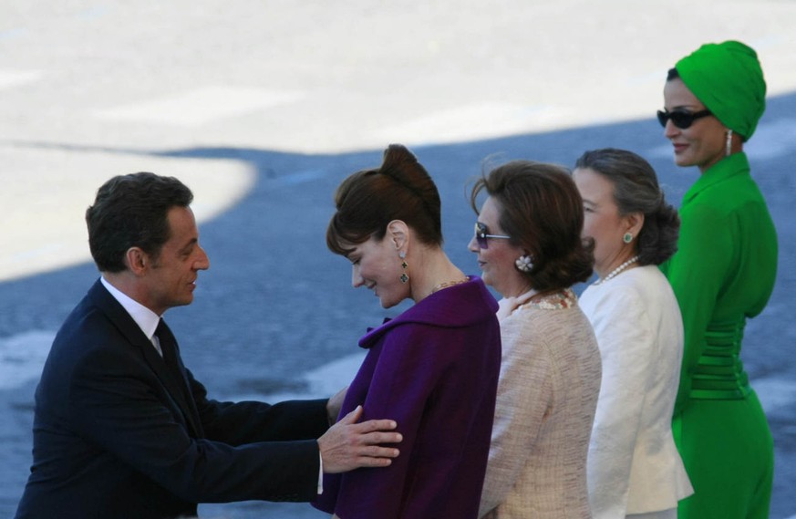 French President Nicolas Sarkozy greets his wife Carla Bruni Sarkozy and other spouses during the Bastille day ceremonies in Paris. Monday July 14, 2008. Leaders from Europe, the Middle East and North ...