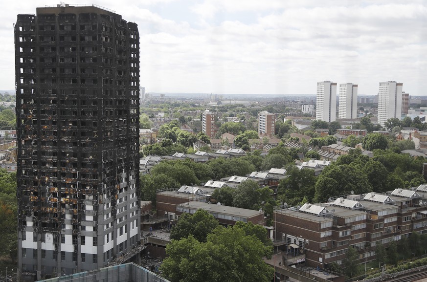 The burnt Grenfell Tower apartment building stands testament to the recent fire in London, Friday, June 23, 2017. British officials have ordered an immediate examination Friday, into a fridge-freezer  ...