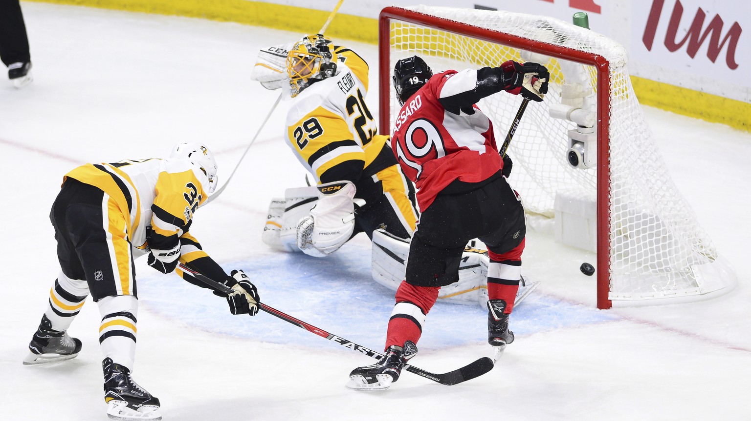 Ottawa Senators centre Derick Brassard (19) scores against Pittsburgh Penguins goalie Marc-Andre Fleury (29) as defenseman Mark Streit (32) tries to defend during the first period of game three of the ...