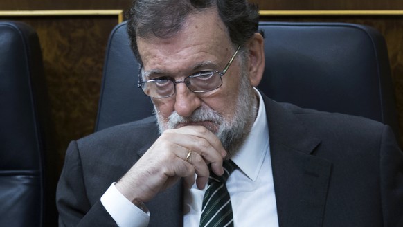 Spain&#039;s Prime Minister Mariano Rajoy listens to lawmakers during a parliamentary session at the parliament in Madrid, Wednesday, Oct. 18, 2017. About 50 Spanish and Catalan party lawmakers held u ...