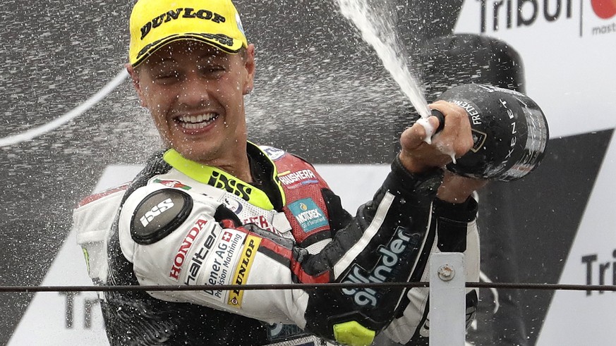 Moto 2 rider Dominique Aegerter of Switzerland celebrates on the podium after winning the San Marino Motorcycle Grand Prix at the Misano circuit in Misano Adriatico, Italy, Sunday, Sept. 10, 2017. (AP ...