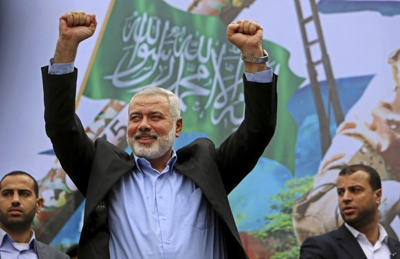 FILE - In this Friday, Dec. 12, 2014 file photo, Palestinian top Hamas leader Ismail Haniyeh greets supporters during a rally to commemorate the 27th anniversary of the Hamas militant group, at the ma ...