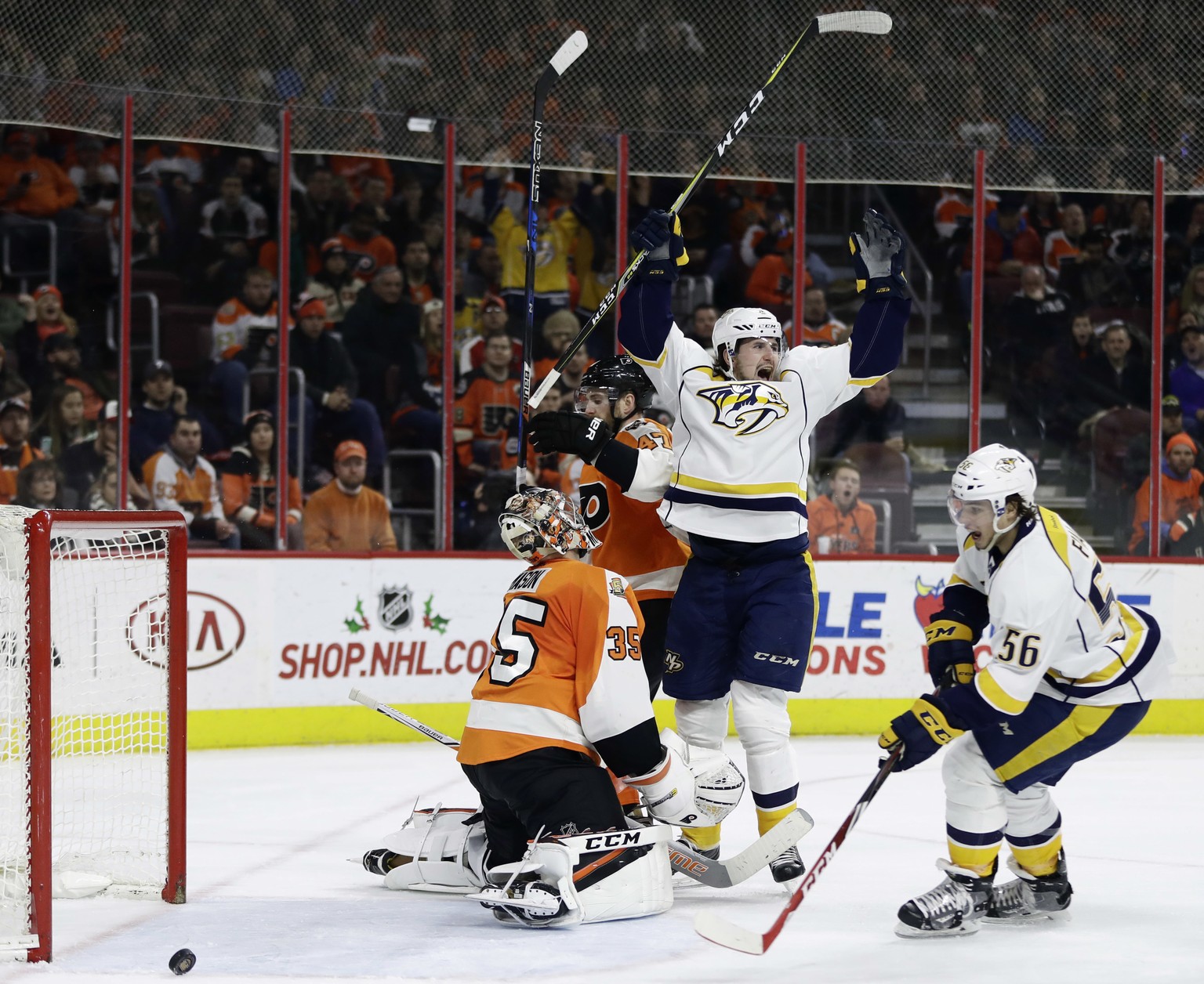 Nashville Predators&#039; Filip Forsberg, center, and Kevin Fiala, right, react after Forsberg scored a goal against Philadelphia Flyers&#039; Steve Mason, left, during the third period of an NHL hock ...