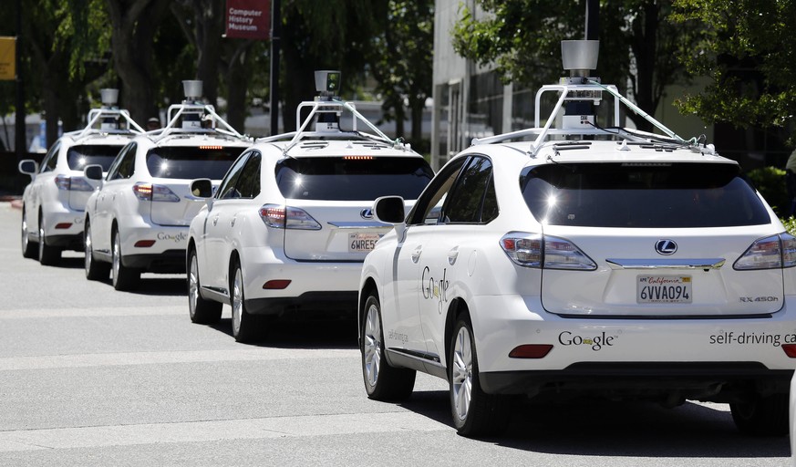FILE - This May 13, 2014, file photo shows a row of Google self-driving Lexus cars at a Google event outside the Computer History Museum in Mountain View, Calif. California regulators release safety r ...
