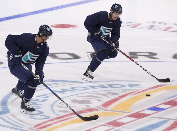 Team Europe&#039;s Luca Sbisa, left, and Mark Streit practice a drill during their first practice session for the World Cup of Hockey tournament, Monday, Sept. 5, 2016, at the Videotron Centre in Queb ...