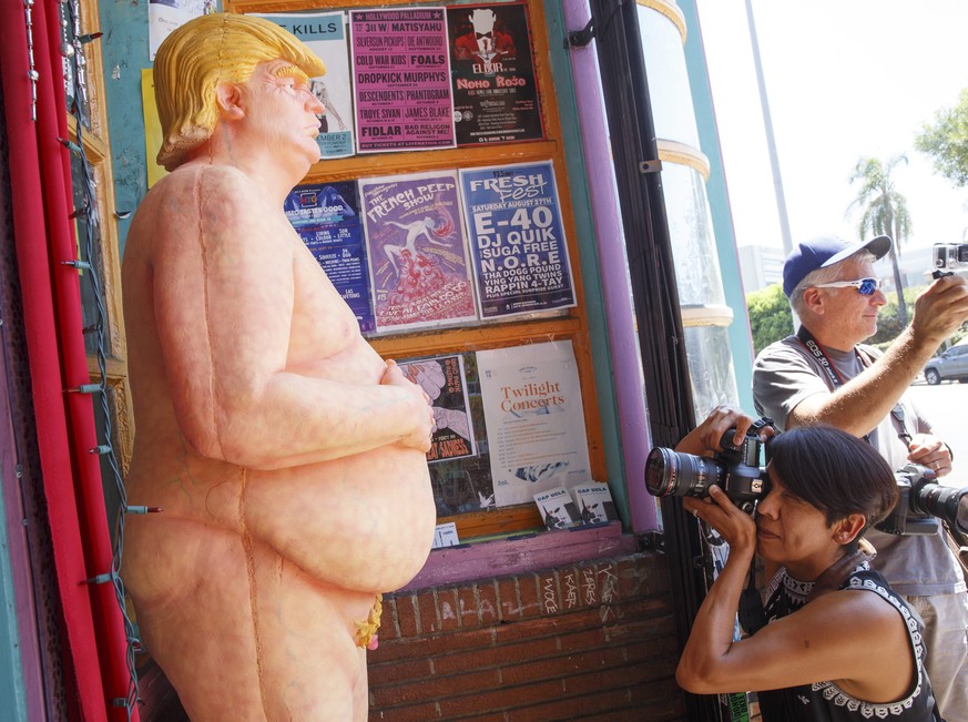 epa05497427 A naked Donald Trump statue gets the attention of passersby after being unveiled around the USA including in Los Angeles, California, USA, 18 August 2016. The unauthorized art installation ...