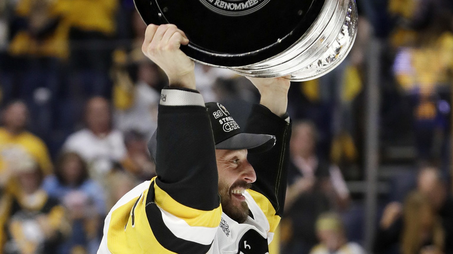 Pittsburgh Penguins defenseman Mark Streit, of Switzerland, celebrates with the Stanley Cup after the Penguins defeated the Nashville Predators 2-0 in Game 6 of the NHL hockey Stanley Cup Finals Sunda ...