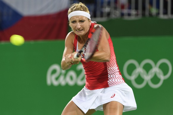 Timea Bacsinszky returns a ball next to Martina Hingis, not pictured, of Switzerland during the women&#039;s semi-final doubles match against Andrea Hlavackova and Lucie Hradecka from Czech Republic a ...