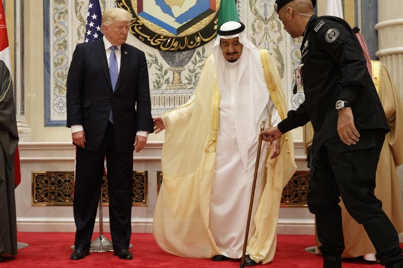 U.S. President Donald Trump, left, stands with Saudi King Salman during a photo with leaders at the Gulf Cooperation Council meeting, at the King Abdulaziz Conference Center, Sunday, May 21, 2017, in  ...