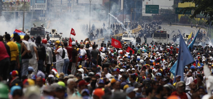 An anti-government protest against Venezuelan President Nicolas Maduro&#039;s decree kicking off the process to rewrite the constitution is met with tear gas from the Bolivarian National Guard in Cara ...