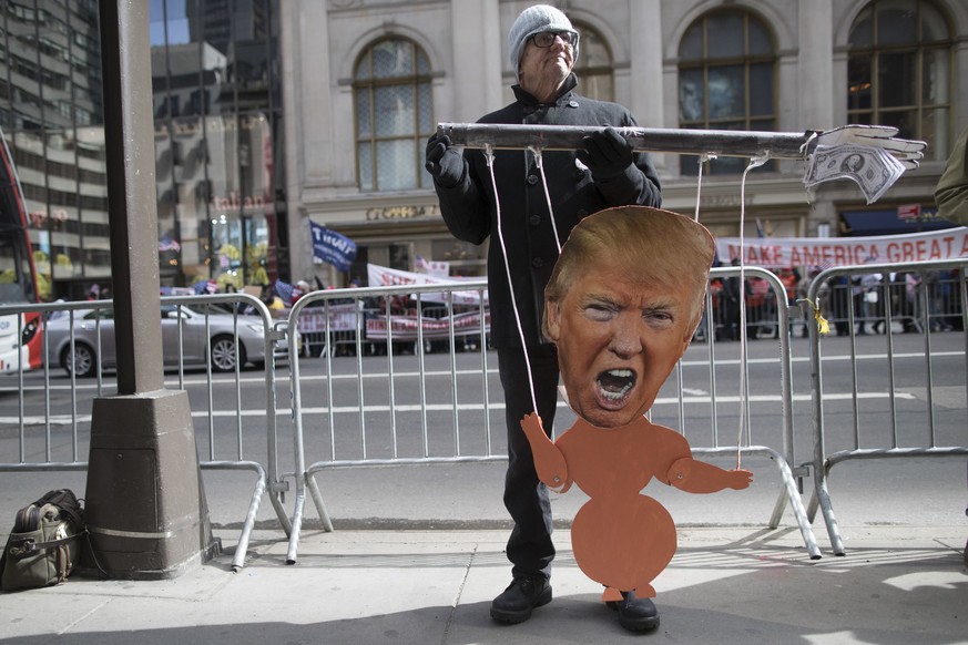 An anti-President Donald Trump demonstrators holds a Trump puppet during a counter-rally to the March 4 Trump rally on Fifth Avenue near Trump tower, Saturday, March 4, 2017, in New York. (AP Photo/Ma ...