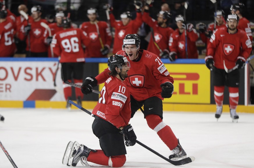 Switzerland&#039;s Andres Ambuhl, left, celebrates with teammate Joel Genazzi, right, after scoring his sides second goal during the Ice Hockey World Championships group B match between Switzerland an ...