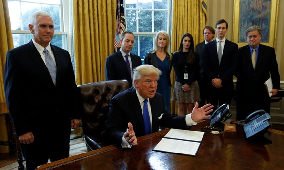 U.S. President Donald Trump speaks to reporters while signing an executive order to advance construction of the Keystone XL pipeline at the White House in Washington January 24, 2017. REUTERS/Kevin La ...