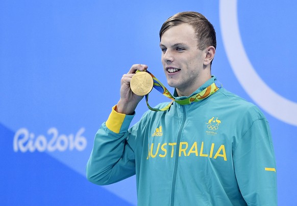 Australia&#039;s Kyle Chalmers shows off his gold medal during the men&#039;s 100-meter freestyle medals ceremony during the swimming competitions at the 2016 Summer Olympics, Thursday, Aug. 11, 2016, ...