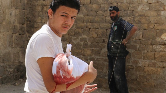 ATTENTION EDITORS - VISUALS COVERAGE OF SCENES OF DEATH OR INJURY A man carries the body of a dead child after an airstrike in the rebel held Bab al-Nairab neighborhood of Aleppo, Syria, August 25, 20 ...