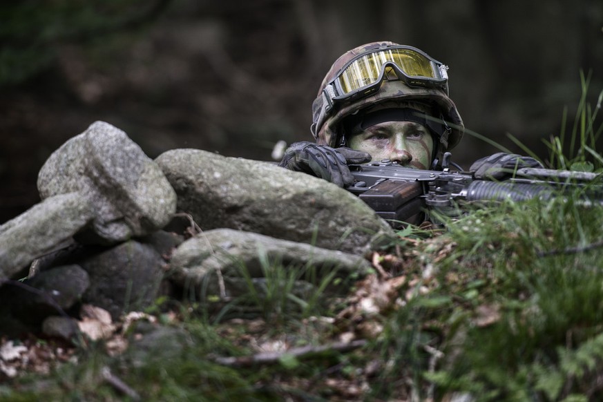 A grenadier recruit peers over the edge of the trench, pictured during an urban warfare exercize of the grenadier recruit school of the Swiss Armed Forces in Isone, canton of Ticino, Switzerland, on J ...
