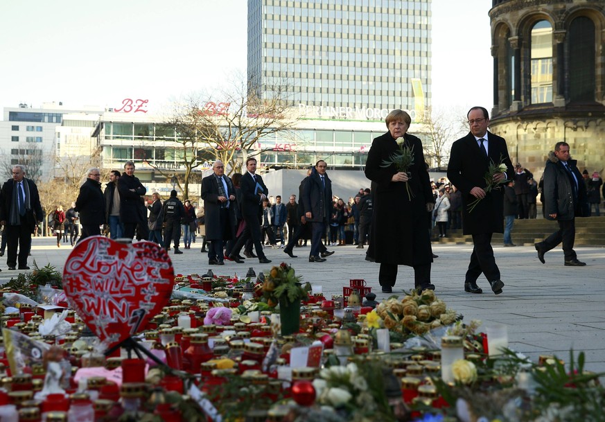 German Chancellor Angela Merkel and French President Francois Hollande visit the site where on December 19, 2016 a truck ploughed through a crowd at a Christmas market on Breitscheidplatz square in Be ...