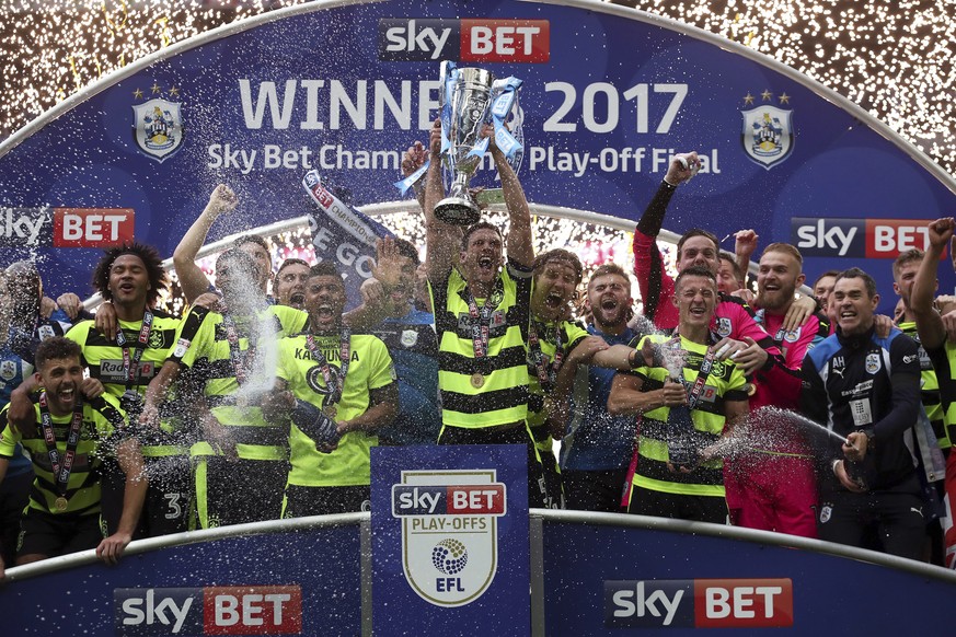 Huddersfield Town&#039;s Mark Hudson lifts the trophy after winning the Sky Bet Championship play-off final at Wembley Stadium, London, Monday, May 29, 2017. Huddersfield Town will play in England&#03 ...
