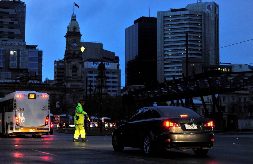 Police direct traffic in the central business district (CBD) of Adelaide after severe storms and thousands of lightning strikes knocked out power to the entire state of South Australia, September 28,  ...
