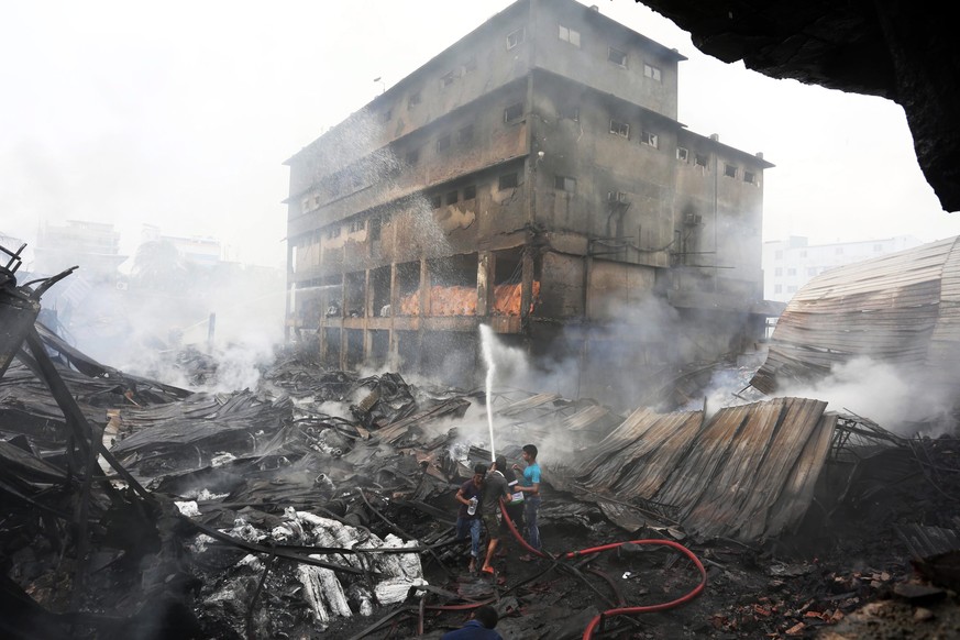 epa05534742 Firefighters try to douse flames, following a boiler explosion in a factory in Tongi, Bangladesh, 11 September 2016. According to news reports, the death toll has climbed to 27 with many o ...