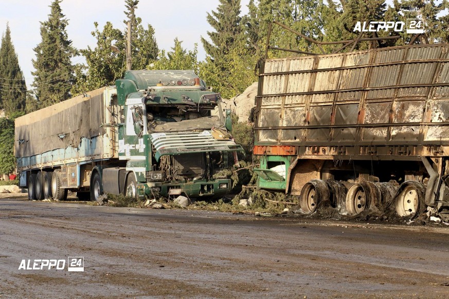 This image provided by the Syrian anti-government group Aleppo 24 news, shows damaged trucks carrying aid, in Aleppo, Syria, Tuesday, Sept. 20, 2016. A U.N. humanitarian aid convoy in Syria was hit by ...