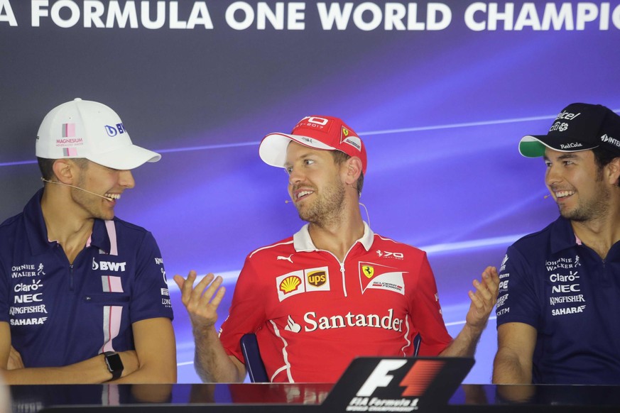 epa06174356 Ferrari German driver Sebastian Vettel (C) with Force India French driver Esteban Ocon (L) and Force India Mexican driver Sergio Perez attend a press conference ahead of Formula One Italia ...