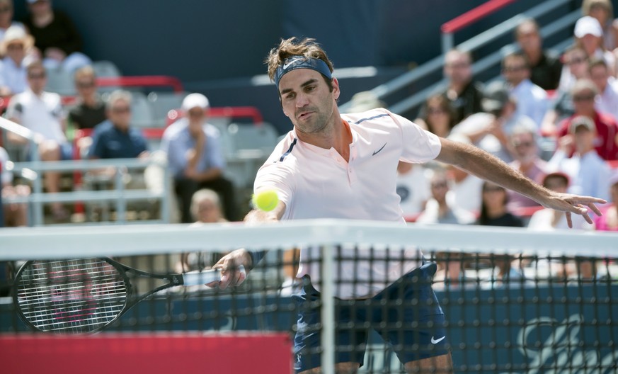 Roger Federer, of Switzerland, goes up to the net as he faces Peter Polansky, of Canada, at the Rogers Cup tennis tournament, Wednesday, Aug. 9, 2017 in Montreal. (Paul Chiasson/The Canadian Press via ...