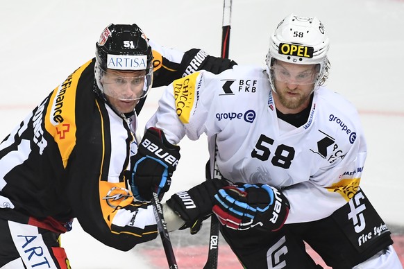 Lugano’s player Ryan Gardner, left, fights for the puck with Fribourg&#039;s player Anton Gustafsson, right, during the preliminary round game of National League A (NLA) Swiss Championship 2016/17 bet ...