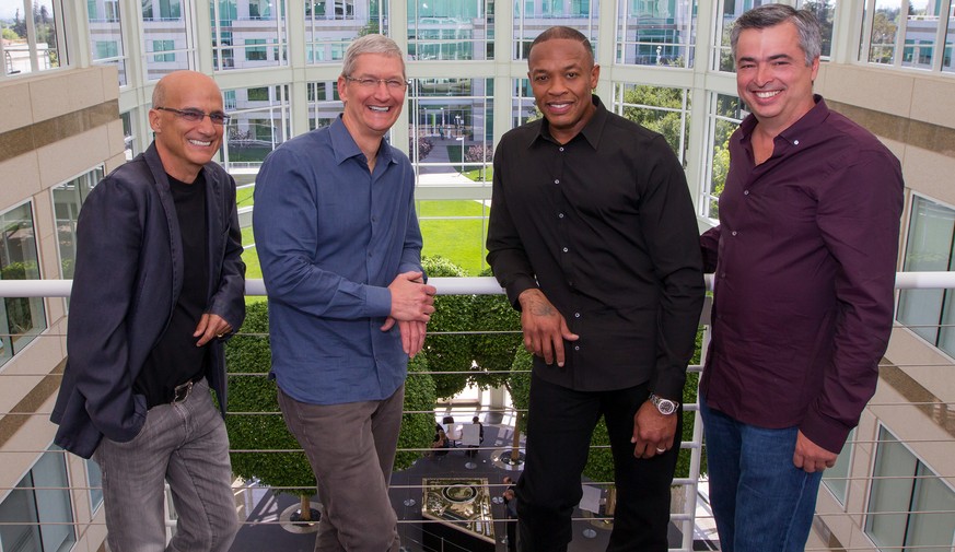 In this image provided by Apple, from left to right, music entrepreneur and Beats co-founder Jimmy Iovine, Apple CEO Tim Cook, Beats co-founder Dr. Dre, and Apple senior vice president Eddy Cue pose t ...