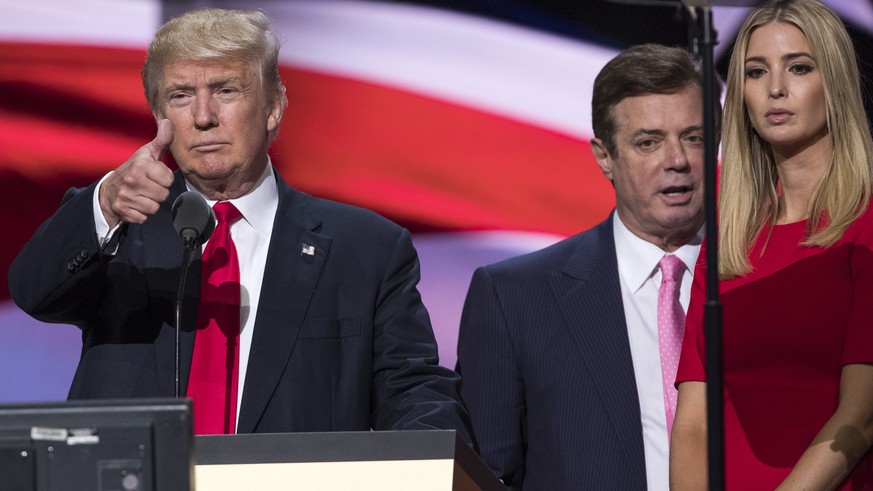 FILE - In this July 21, 2016 file photo, then-Trump Campaign manager Paul Manafort stands between the then-Republican presidential candidate Donald Trump and his daughter Ivanka Trump during a walk th ...