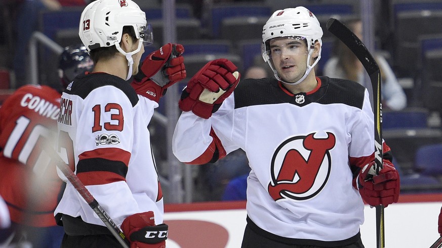New Jersey Devils defenseman Will Butcher (8) celebrates his goal with center Nico Hischier (13), of Switzerland, during the first period of an NHL preseason hockey game against the Washington Capital ...