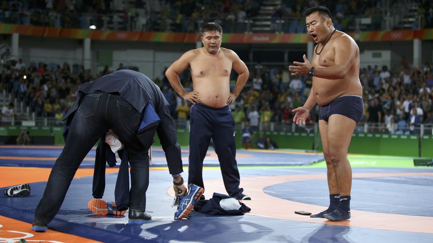 2016 Rio Olympics - Wrestling - Final - Men&#039;s Freestyle 65 kg Bronze - Carioca Arena 2 - Rio de Janeiro, Brazil - 21/08/2016. The coach (R) of Mandakhnaran Ganzorig (MGL) of Mongolia stands undre ...