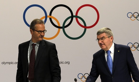 epa04870396 International Olympic Committee (IOC) President, Thomas Bach (R) and IOC Communication Director Mark Adams (L) arrives for a press conference at the Kuala Lumpur Convention Centre, Kuala L ...