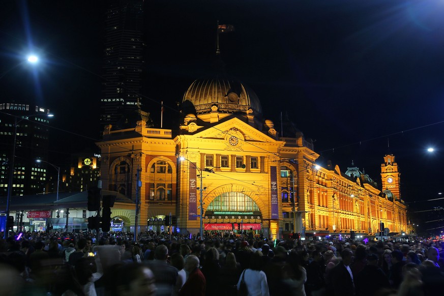 MELBOURNE, AUSTRALIA - FEBRUARY 20: A large crowd is seen outside Flinders Station during White Night Melbourne on February 20, 2016 in Melbourne, Australia. (Photo by Graham Denholm/Getty Images)