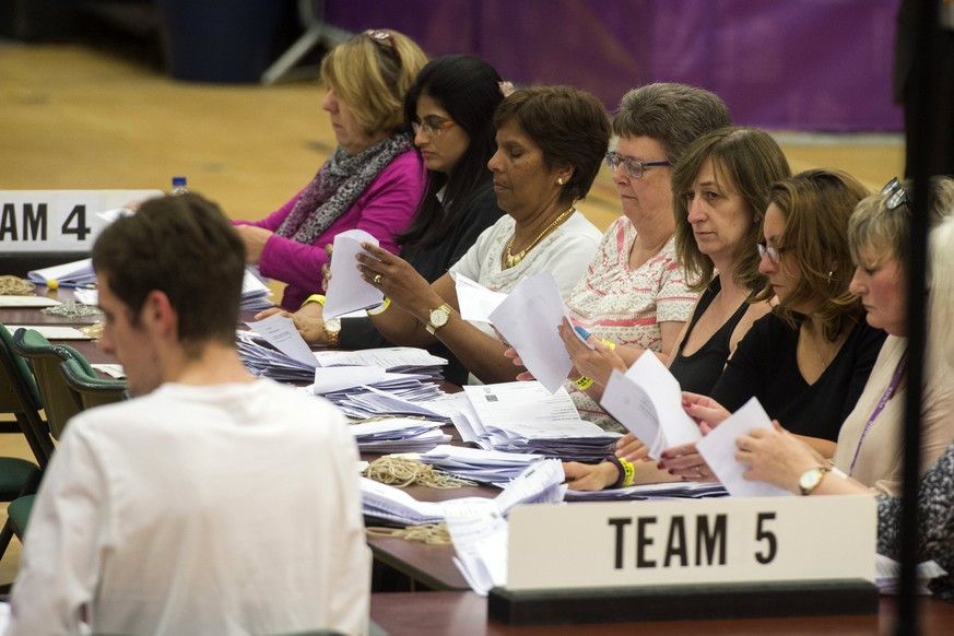 epa06017817 Election officials at the Magnet Leisure Centre count votes cast in the constituency of Maidenhead, Britain, 08 June 2017. British voters went to the polls to cast their ballot to elect a  ...