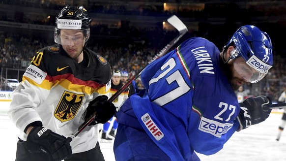 Italy&#039;s Thomas Larkin, right, and Germany&#039;s Patrick Hager in action during the Ice Hockey World Championship group A match between Italy and Germany at the Lanxess Arena in Cologne, Germany, ...