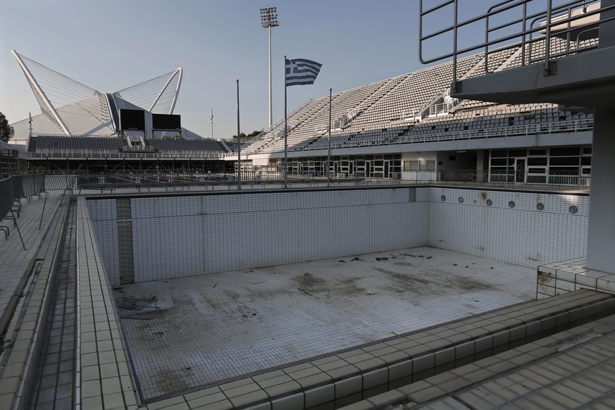 epa04351719 A picture made available on 13 August 2014 of the abandoned Olympic Aquatic Centre that hosted the diving competitions of the 2004 Summer Olympic Games at the Olympic Sports Complex in Ath ...