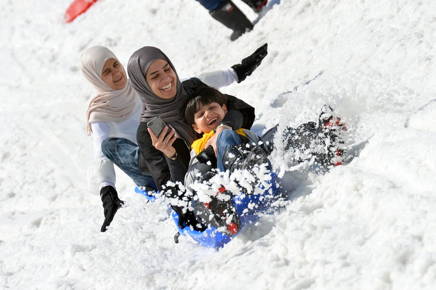 Tourists from Saudi Arabia enjoy a ride on a bob sled on the glacier of the Kitzsteinhorn mountain in Kaprun, in the Austrian province of Salzburg, Wednesday, June 10, 2015. This alpine area around Ka ...