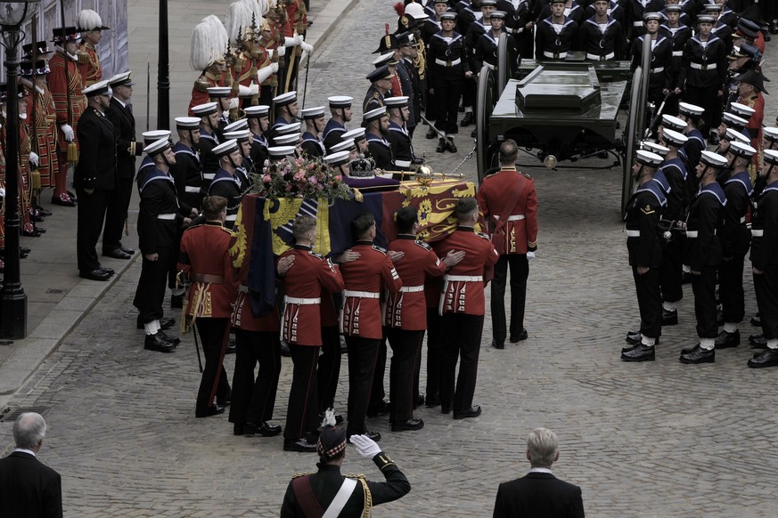 The coffin of Queen Elizabeth II is loaded on to a gun carriage pulled by Royal Navy soldiers to go from Westminster Hall for her funeral service in Westminster Abbey in central London, Monday Sept. 1 ...