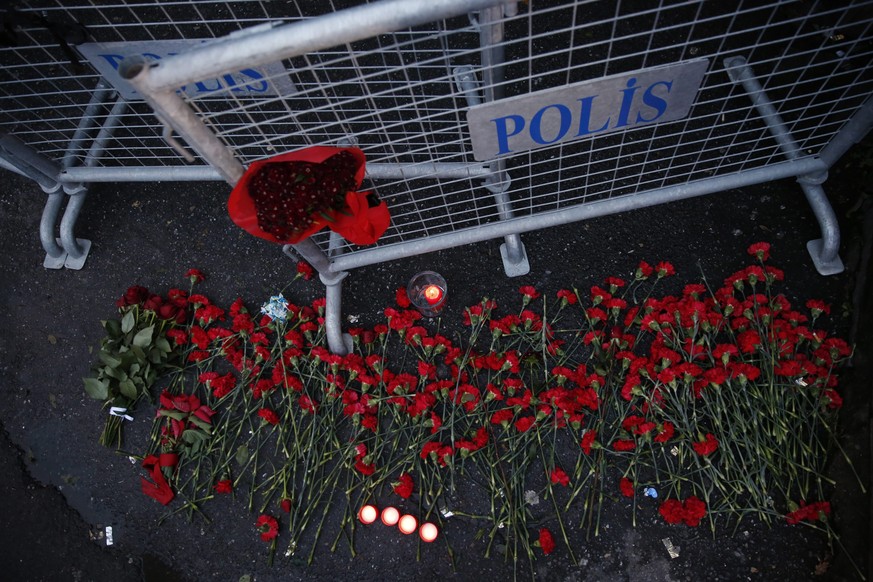 epa05694416 People place flowers and candles at a police barrier in front of the Reina night club following a gun attack at the popular night club in Istanbul close to the Bosphorus river, in Istanbul ...