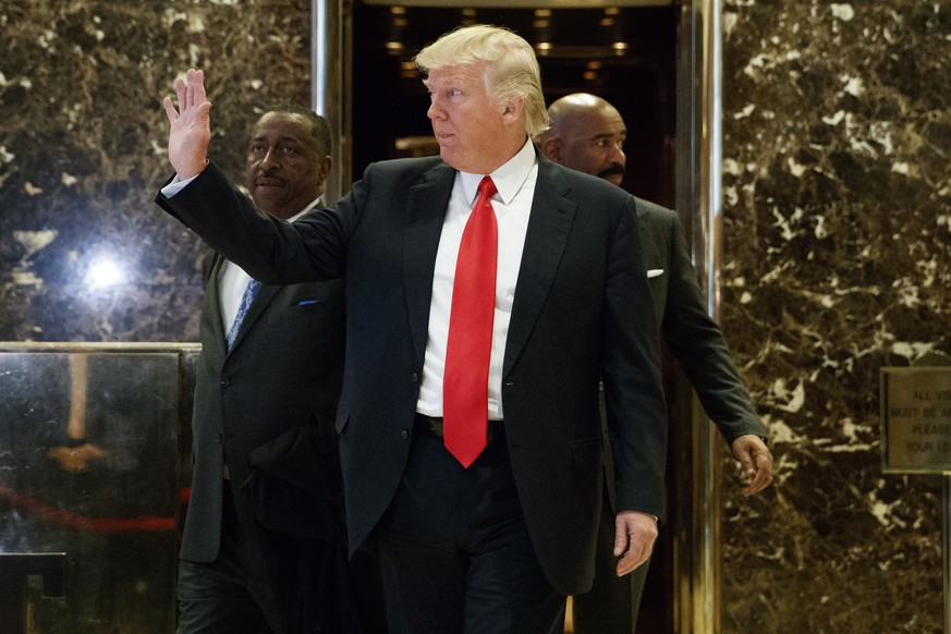 President-elect Donald Trump waves as he walks out of the elevator in the lobby of Trump Tower in New York, Friday, Jan. 13, 2017. (AP Photo/Evan Vucci)