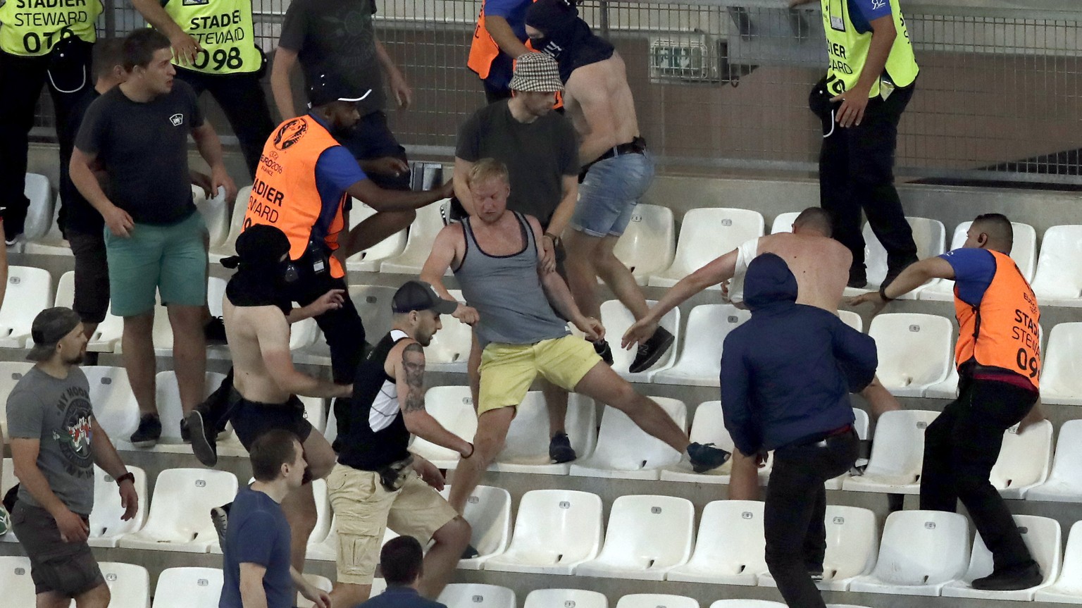 Supporters and stewards clash in the stands after the Euro 2016 Group B soccer match between England and Russia at the Velodrome stadium in Marseille, France, Saturday, June 11, 2016. (AP Photo/Ariel  ...