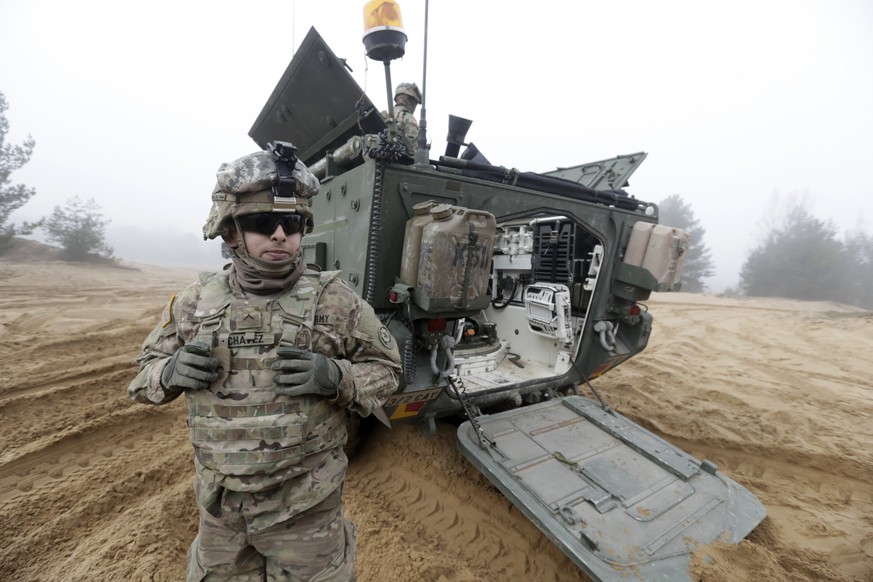 Soldiers of the U.S. Army&#039;s 2nd Cavalry Regiment, deployed in Latvia as part of NATO&#039;s Operation Atlantic Resolve, are pictured near their armored vehicle named &quot;Stryker&quot; during a  ...