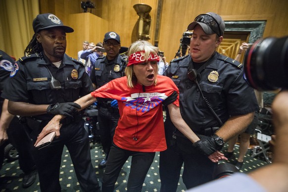 epa06227035 Protestors against the Graham-Cassidy Health Care Bill are removed prior to a Senate Finance Committee about the controversial bill in the Dirksen Senate Office Building in Washington, DC, ...