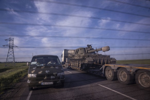 A truck transports a platform with a Ukrainian self-propelled artillery vehicle in Donetsk region, Ukraine, on Thursday, May 12, 2022. (AP Photo/Evgeniy Maloletka)