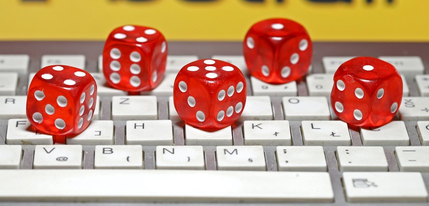 Betfair logo is seen behind a keyboard and gambling dice in this illustration taken in Sarajevo, September 10, 2015. Betfair and Irish rival Paddy Power have reached agreement on a 6 billion pound com ...