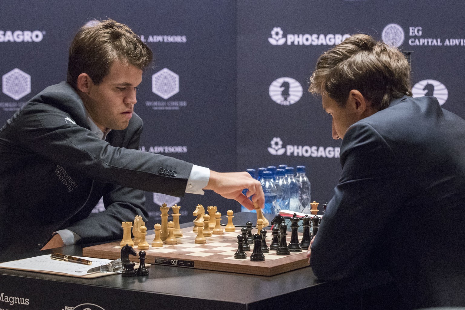 Chess world champion Magnus Carlsen, of Norway, left, makes a move against challenger Sergey Karjakin, of Russia, during the first round of the World Chess Championship, Friday, Nov. 11, 2016, in New  ...