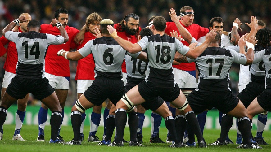 French players face down their New Zealand counterparts who perform their pre-match Haka before the Rugby World Cup quarterfinal match between France and New Zealand at the Millennium Stadium in Cardi ...
