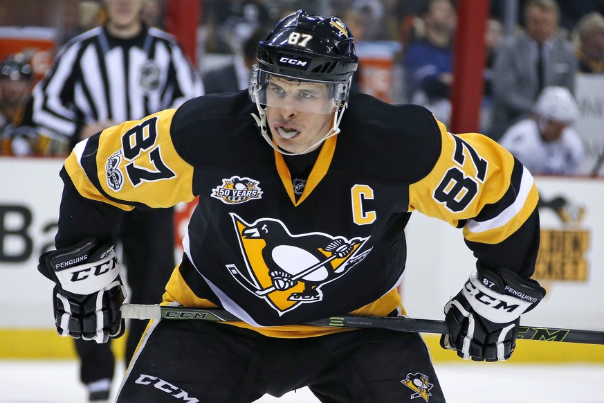 FILE - In this March 3, 2017, file photo, Pittsburgh Penguins&#039; Sidney Crosby prepares for a face-off in the second period of an NHL hockey game against the Tampa Bay Lightning in Pittsburgh. The  ...