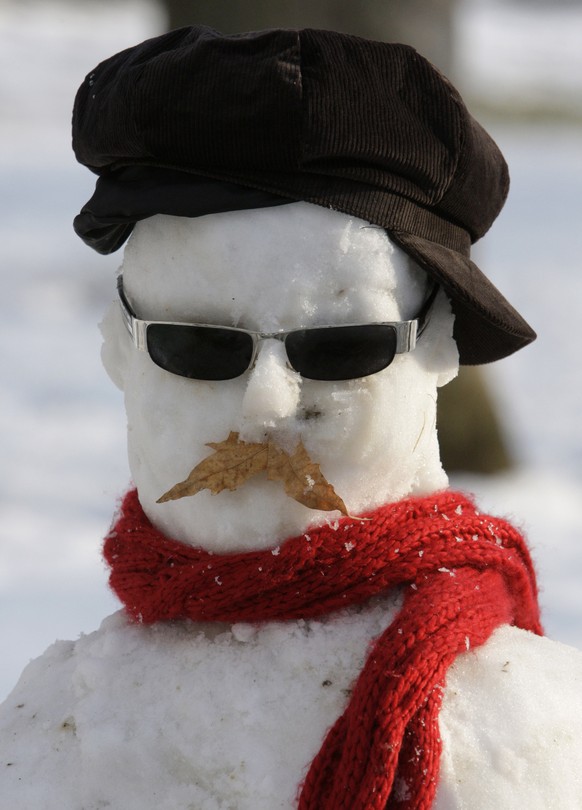 A snowman sporting smart hat and scarf at the Mellat (Nation) Park in northern Tehran, Iran, Saturday, Jan. 21, 2012. Snow forced authorities to close schools in some parts of Tehran and other cities  ...